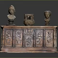 Antique Wooden Cabinet Featuring Carved Designs With Two Small Busts And Pottery Jar On Top