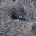Off Road Vehicle Tackling Steep Rocky Terrain During Mountain Adventure