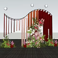 Wedding Decoration Setup With Vertical Red Orange Panels And Floral Arrangement On Wooden Floor