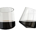 Clear Glass Wine Bottle And Wine Glasses With Dark Liquid In Standing And Leaning Positions