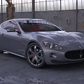 Gray Maserati Sports Car Parked In Industrial Garage With Large Windows