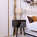 Modern Glossy Black Bedside Table With Table Lamp Photo Frames And Decorative Items In Bedroom