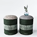 Green Barrel Style Stools with Upholstered Tops Small Vase and Green Plant Featuring Number 1985