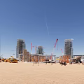 Active Construction Site Featuring Tall Buildings Cranes Heavy Equipment And Blue Sky