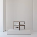 Minimalist Leisure Chair with Light Colored Cushion and Wooden Frame on Display Platform