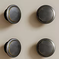 Round Black Knobs With Gold Trim Mounted On Light Background Wall 3d model