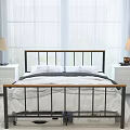 Black Metal Frame Double Bed With White Sheets And Nightstands In Bright Bedroom