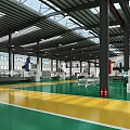 Industrial Factory Interior With Green Yellow Floor Steel Beams And Machinery