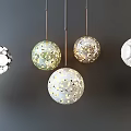 Various Spherical Pendant Lights With Decorative Patterns And White Gold Accents On Dark Background