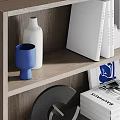 Stylish Modern Display Cabinet Featuring Layered Shelves With Decorative Vases Books And Artworks