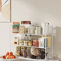 White Wire Kitchen Shelving Unit with Noodles Boxes Rice Bags Glass Cups and Storage Jars