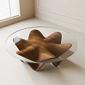 Modern Minimalist Coffee Table With Glass Top And Irregular Wooden Base In Bright Room
