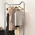 Metal Clothes Rack With Hanging Clothes And Storage Basket In Bedroom