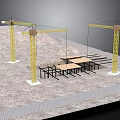 Construction Site With Yellow Tower Cranes And Steel Building Frame On Sandy Ground