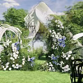 Outdoor Wedding Floral Display with White Blue Blooms Green Foliage and Welcome Sign