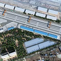 Aerial View Planning of Modern Industrial Park With Warehouses Cranes and Blue Water Areas