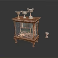 Wooden Display Cabinet with Glass Door Trophies on Top and One Trophy Fallen on Floor