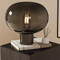 Black Round Glass Shade Table Lamp on Stacked Books with Aromatherapy Sticks