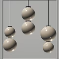 Three Modern Pendant Lights With Two Cream Colored Spherical Shades And Black Accents