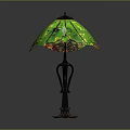 Decorative Table Lamp With Intricate Black Metal Base And Green Stained Glass Shade
