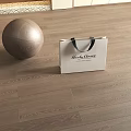 Elegant Wooden Flooring With Silver Metallic Ball And Vince Camuto White Shopping Bag