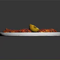 Spicy Seasoned Meat Slices Served On White Plate With Lemon Wedge