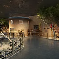 Cultural Center Featuring Circular Mud Brick Building Dark Roof Surrounding Trees And Wooden Fences
