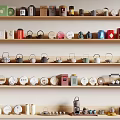 Various Tea Wares Displayed On Multi Layer Shelves With Teapots Cups And Canisters
