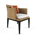 Stylish Wicker Armchair With Black Legs White Cushion And Red Patterned Pillow