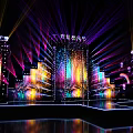 Vibrant Stage Setup With Colorful Lights And Large Screens For Event Performance
