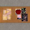 Corkboard Wall Decor with Various Artworks Including Apple Sunset and Fireworks and Side Light Fixtures