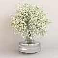White Baby's Breath Flowers In Transparent Glass Vase With Round Base On Light Gray Tabletop