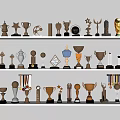Trophies And Medals Display On White Shelves With Various Shapes And Metallic Colors