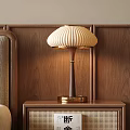 Pleated Beige Table Lamp on Brown Bedside Table with Wooden Wall Background