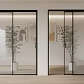 Glass Folding Doors With Black Frame In Modern Interior Space With Potted Plants And Artworks