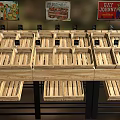 Wooden Shelving Unit with Multiple Wooden Crates for Product Display and Hanging Signboards on Top