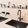 Modern Black Faucets Display Multiple Styles Installed on Sinks in Showroom with Flowing Water