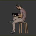 Man Sitting On Wooden Stool Reading Book In Purple T-Shirt And Khaki Pants