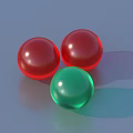 Gold Circular Jewelry Pieces With Square Holes And Red Green Round Beads On Blue Background