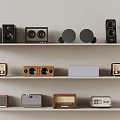 Collection Of Vintage Radios And Modern Speakers On Display Shelves