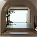 Bright Hotel Public Lounge Area With Arched Doorway Beige Walls Plant Armchair And Fireplace