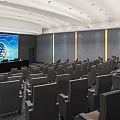 Modern Conference Room With Rows Of Seats Large Screen Data Display And Bright Lighting
