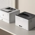 Office Appliances Two White And Gray HP Printers On Modern Office Desk Setup