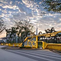 Modern Outdoor Chair In Yellow Park Setting With Trees And Cloudy Sky Surroundings