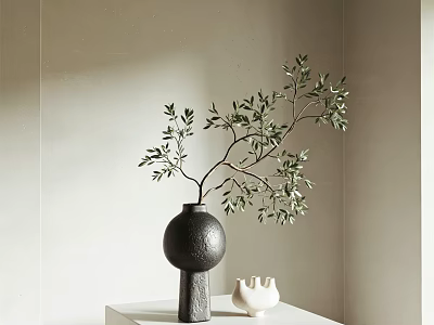 Black Vase With Branch And Green Leaves On White Table With Small White Decoration 3d model