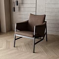 Modern Design Brown Leisure Chair with Metal Frame on Herringbone Wooden Floor and Indoor Plant
