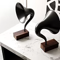 Modern Black Horn Shaped Speakers With Wooden Bases On Marble Tabletop