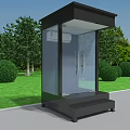 Black Glass Security Booth on Green Lawn with Trees and Bushes by Roadside