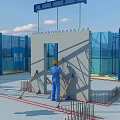 Construction Site Worker In Yellow Hard Hat Working On Concrete Wall With Blue Safety Barriers
