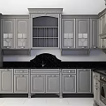 Elegant Gray Kitchen Cabinets With Ornate Carvings And Black Countertop